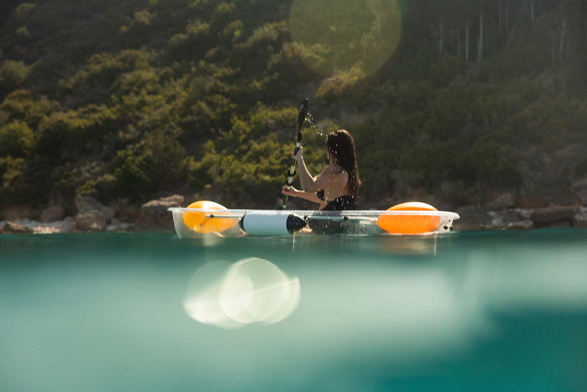 Young woman kayaking in sea at F ZEEN KEFALONIA